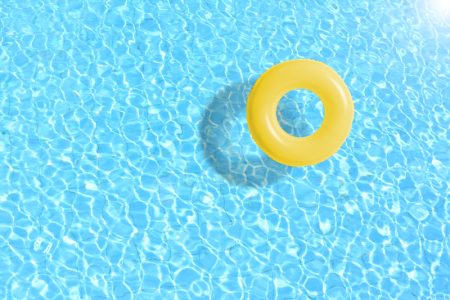 A yellow pool float in pool water.